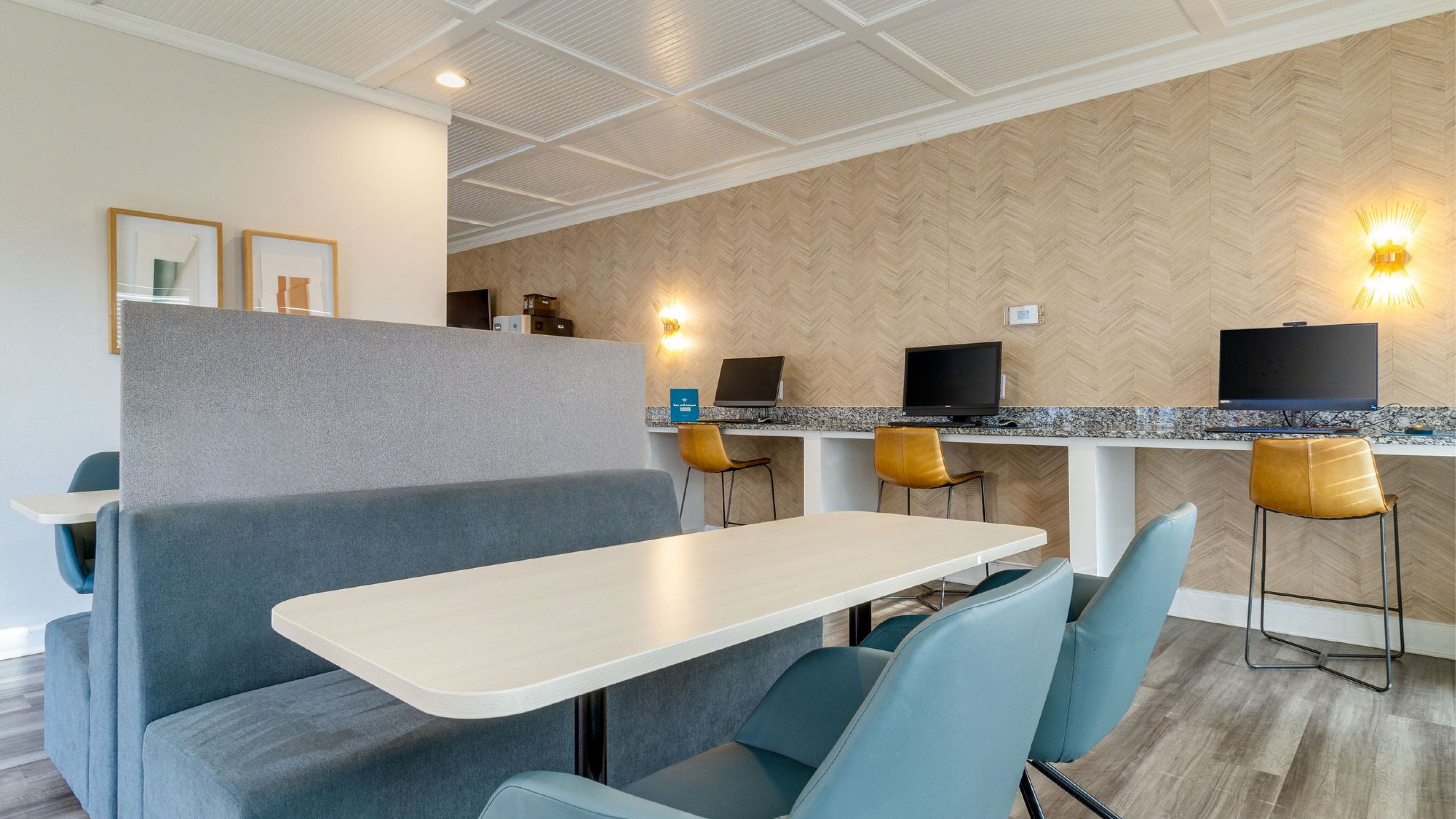 Modern seating booth with bold blue chairs and a work station bar