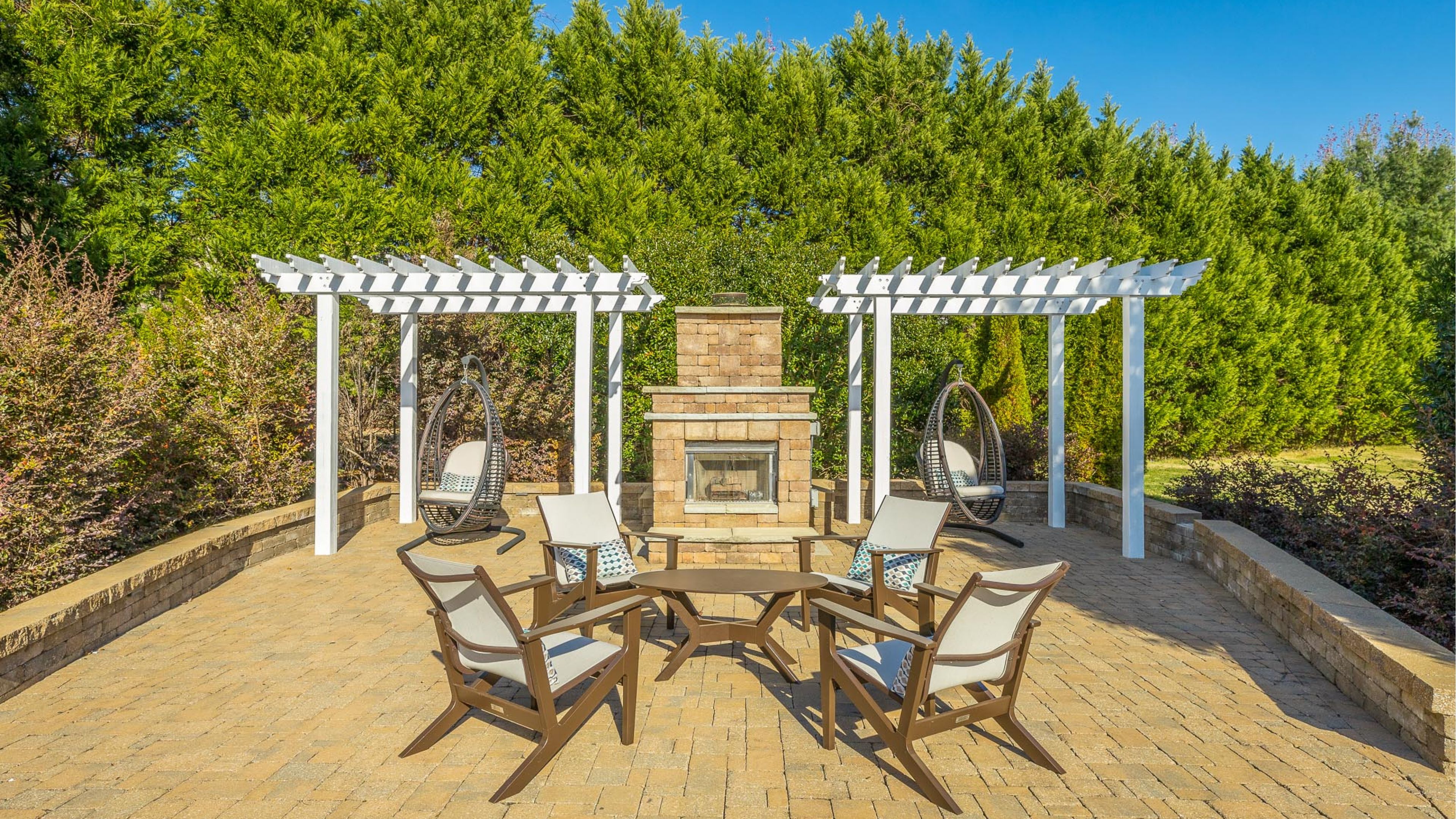 Hawthorne Park South outdoor patio with pergolas, hanging chairs, seating and fireplace
