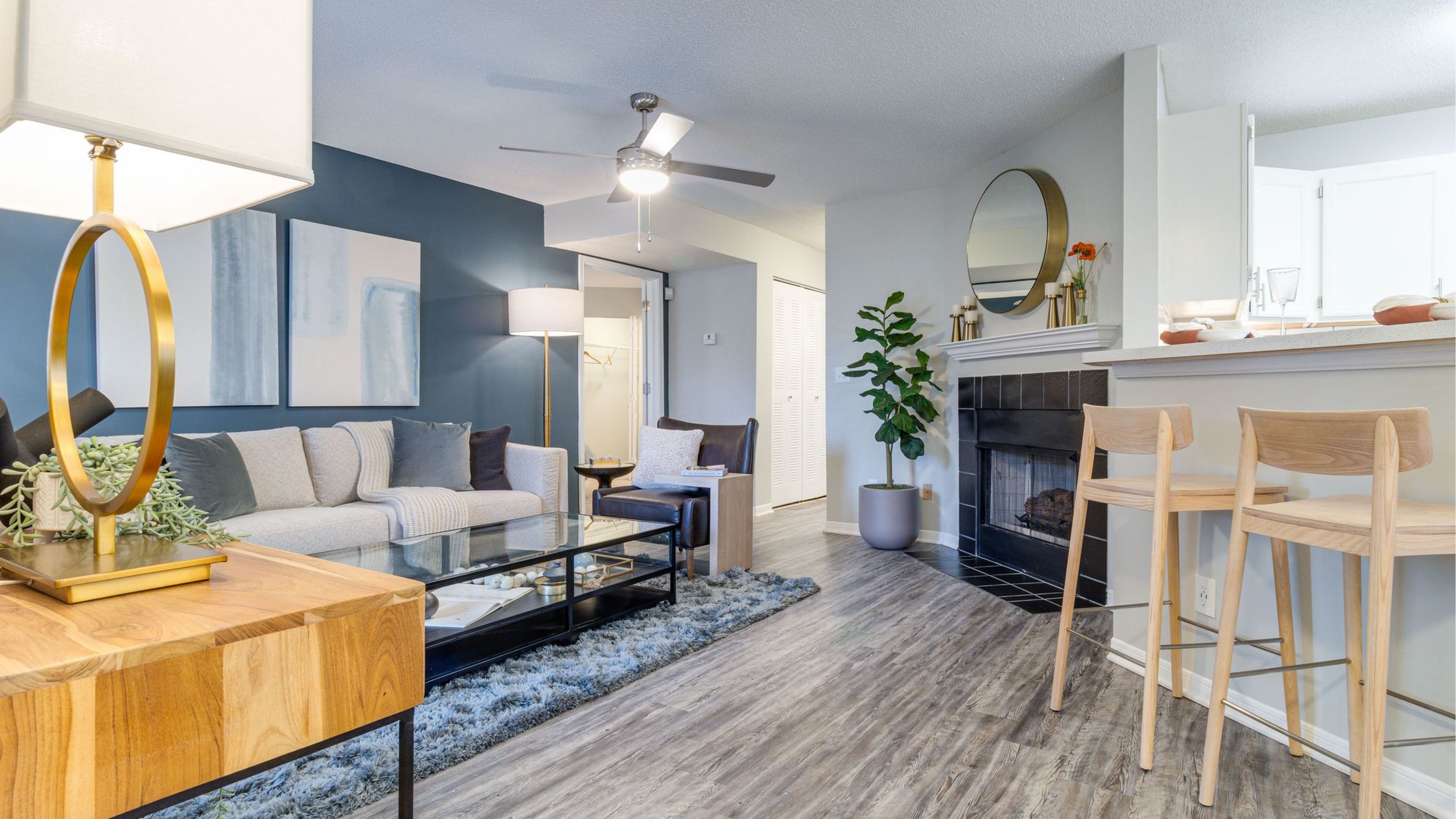 Spacious living room with a fire place and barstools